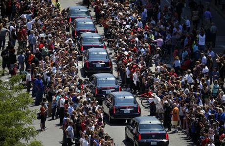 Muhammad Ali's funeral procession passes as onlookers line the street Friday