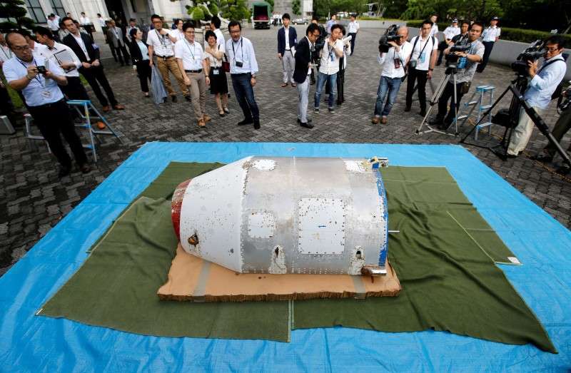 An object suspected to be half of a nose cone from a North Korean rocket launched in February that washed up on a Japanese beach is shown to the media at the Defense Ministry in Tokyo Japan