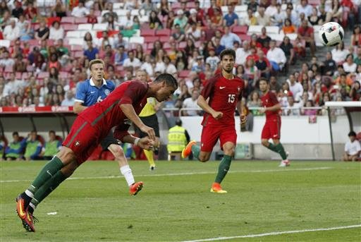 Portugal's Cristiano Ronaldo heads the ball to score against Estonia during a friendly soccer match in Lisbon Portugal. American soccer fans can watch a quintuple-header of major international tournament matches S