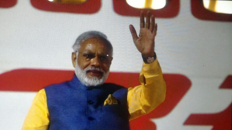 Narendra Modi waves before heading back to Delhi