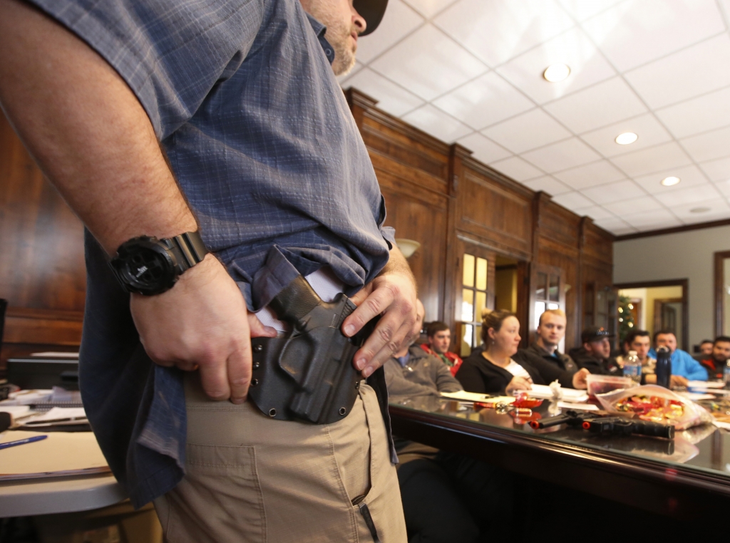 Damon Thueson shows a holster at a gun concealed carry permit class put on by'USA Firearms Training