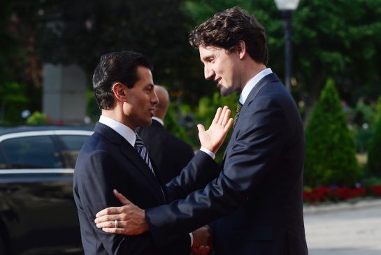 Canadian Prime Minister Justin Trudeau right greets Mexican President Enrique Pena Nieto at a dinner at Casa Loma in Toronto on Monday