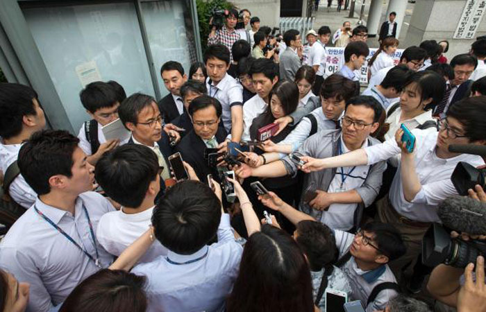 Chae Hee-Joon center a member of the liberal South Korean legal association called Lawyers for a Democratic Society speaks to the media after leaving Seoul Central Court on Tuesday. — AFP