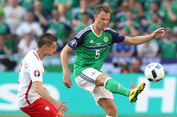 Northern Ireland's Jonny Evans with Poland's Jakub Blaszcykowski. INLT 24-927-CON