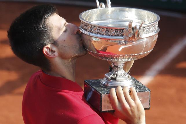 Novak Djokovic celebrates with his trophy