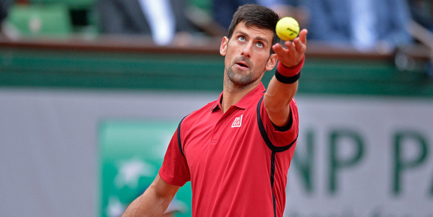 Novak Djokovic prepares to serve in the French Open