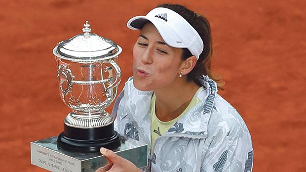 Garbine Muguruza holds the French Open trophy yesterday