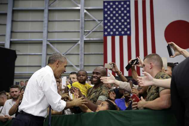 U.S. President Barack Obama is greeted by U.S. Marines and their families at Iwakuni air station in Iwakuni Japan Friday