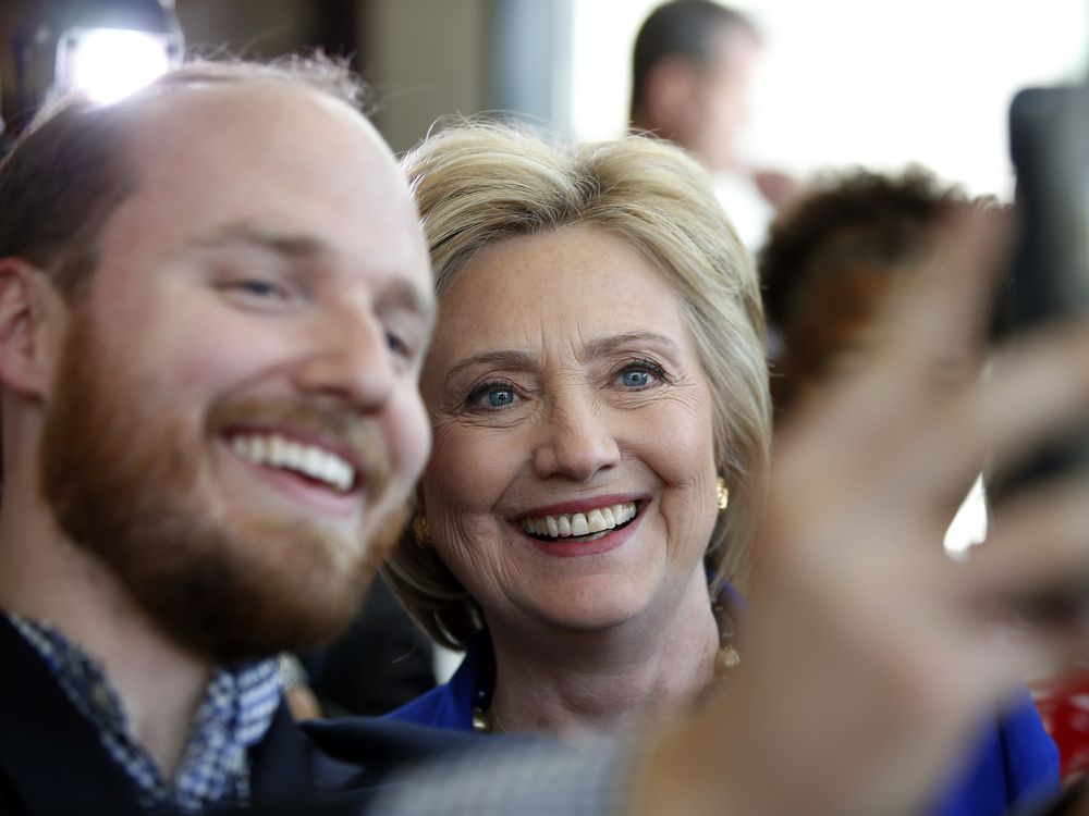 Democratic presidential candidate Hillary Clinton takes a selfie during a stop at Uprising Muffin Company Friday