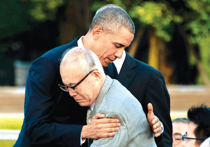 Overwhelmed US President Barack Obama hugs Shigeaki Mori a survivor of the 1945 atomic bombing of Hiroshima during a visit to the Hiroshima Peace Memorial Park yesterday. Pic  AFP