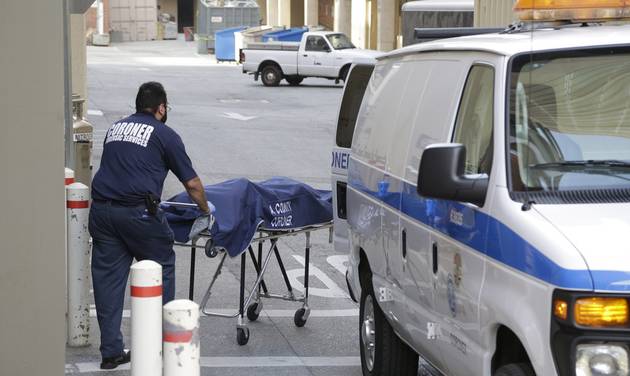 A person from the Los Angeles County Department of Medical Examiner-Coroner's office removes a body at the scene of a fatal shooting at the University of California Los Angeles Wednesday