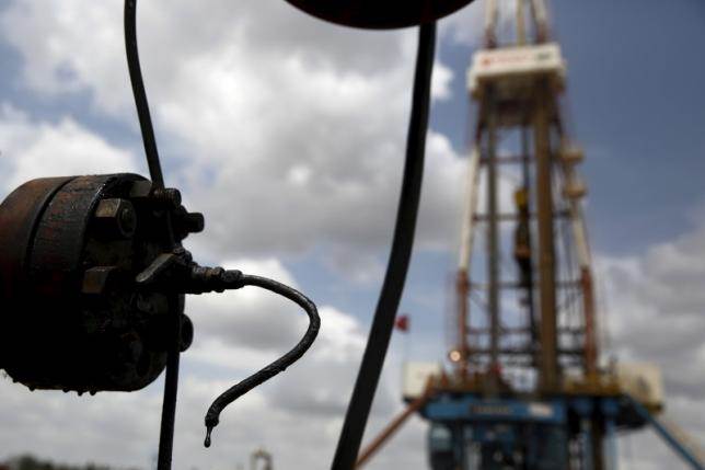 Crude oil drips from a valve at an oil well operated by Venezuela's state oil company PDVSA in the oil rich Orinoco belt near Morichal at the state of Monagas