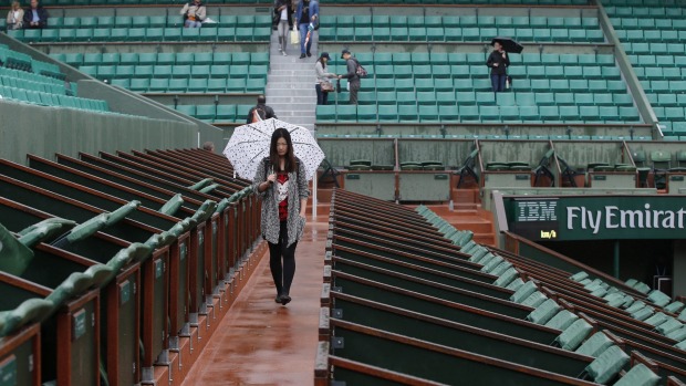 On hold The action at Roland Garros was suspended on Monday due to heavy downpours