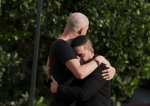 Mourners embrace outside the visitation for Pulse nightclub shooting victim Javier Jorge Reyes Wednesday