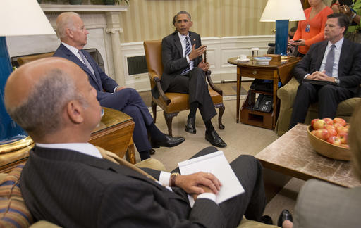 President Barack Obama center speaks to members of the media in the Oval Office of the White House in Washington Monday