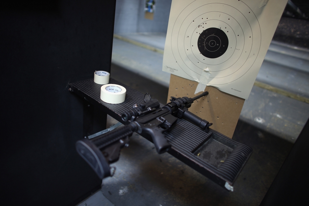 An AR-15 semi-automatic rifle is seen next to a target in the indoor gun range at the National Armory gun store