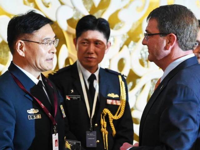 PLA Admiral Sun Jianguo who is leading the Chinese delegation chats with US Secretary