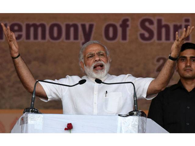 Indian Prime Minister Narendra Modi gestures as he addresses the audience during the swearing-in ceremony of Sarbananda Sonowal as the Chief Minister of the north-eastern state of Assam in Guwahati