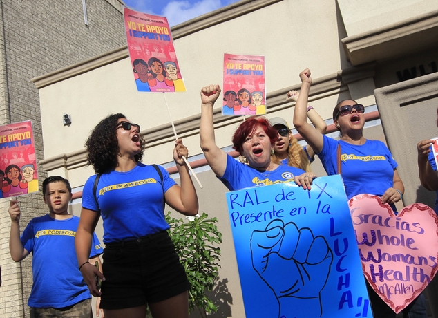 Lucy Ceballos center and Isabella Soto left members of the National Institute for Reproductive Health celebrate the U.S. Supreme Court ruling against Te