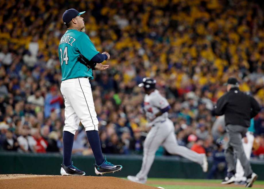 Seattle Mariners starting pitcher Felix Hernandez left waits as Minnesota Twins Miguel Sano rounds the bases on a home run during the second inning of a baseball game Friday