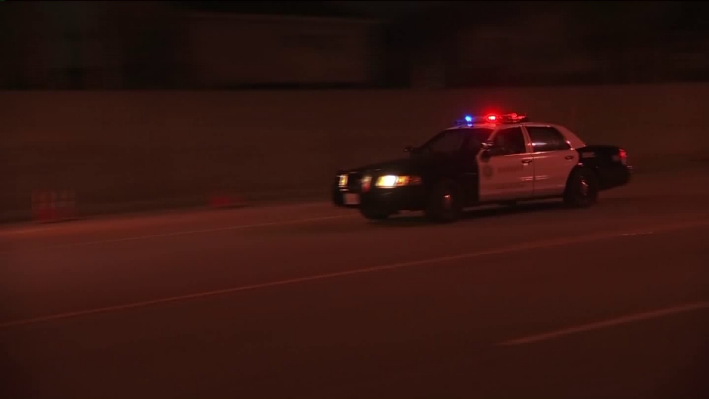 Patrol cars searched the area where two deputies were wounded during a shooting in Bellflower