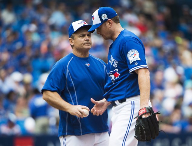 Toronto Blue Jays manager John Gibbons left takes the ball away from Toronto Blue Jays relief pitcher Gavin Floyd while playing against the Boston Red