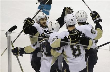 Pittsburgh Penguins players celebrate after defenseman Brian Dumoulin scored against the San Jose Sharks during the first period of Game 6 of the NHL hockey Stanley Cup Finals in San Jose Calif. Sunday