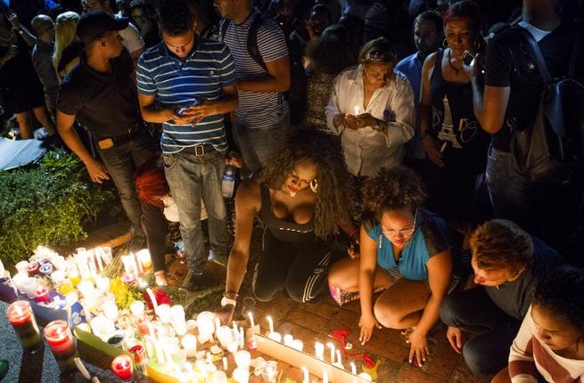 People light candles at a memorial gathering for those killed in Orlando at the Colonial Zone in Santo Domingo