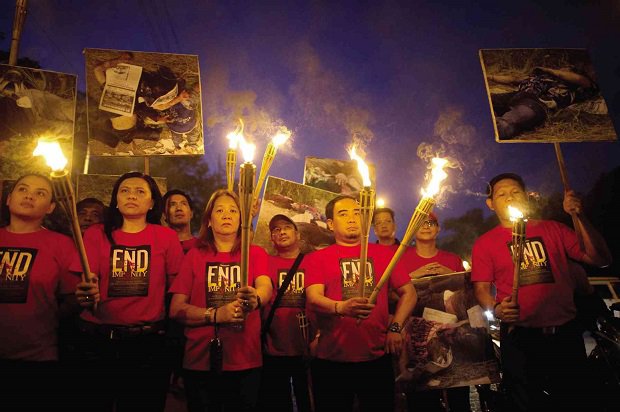 Students and media groups participate in a torch parade in November 2014 condemning the slow pace of the trial of the 197 suspects in the Maguindanao massacre where 58 people including 32 media workers were killed. AFP