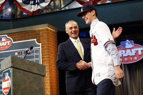 Manfred left shakes hands with Ian Anderson a pitcher from Shenendehowa High School in Clifton Park N.Y. after Anderson was selected with the third pick in the first round by the Atlanta Braves during the baseball dra