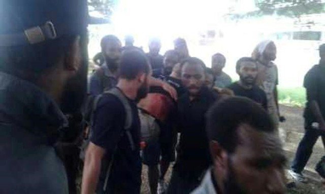 An injured man assisted by others at the University of Papua New Guinea in Port Moresby Papua New Guinea