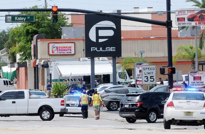 Police officers outside the Pulse nightclub where Omar Mateen opened fire and took hostages on Sunday June 12