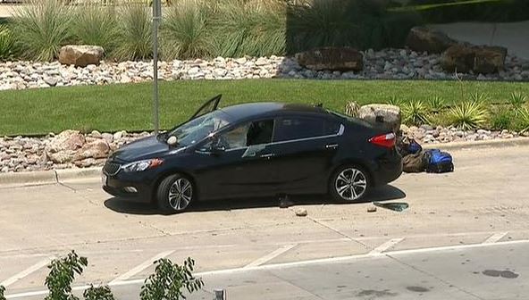 Police say man broke the windows of this car before being shot by an officer