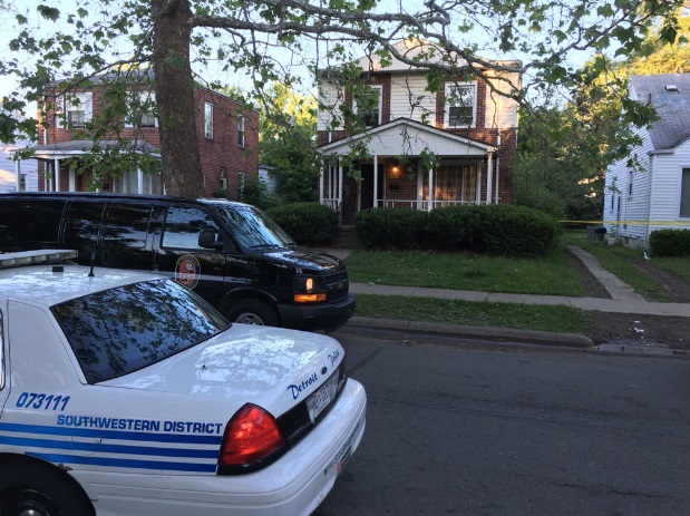 Police tape surrounds a home where three people were killed in Detroit