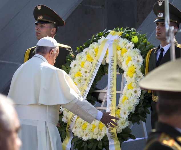 Pope Francis left attends a ceremony at a memorial to Armenians killed by the Ottoman Turks in Yerevan Armenia Saturday