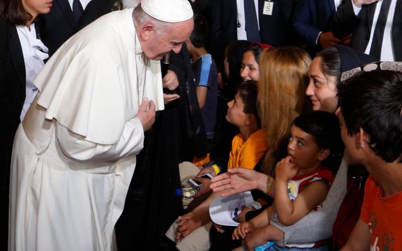 Pope Francis greets a Muslim woman as he meets refugees at the Moria refugee camp on the island of Lesbos