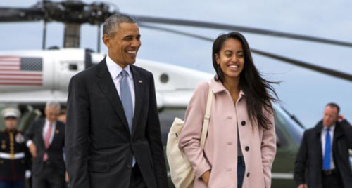 President Barack Obama jokes with his daughter Malia Obama as they walk to board Air Force One from the Marine One helicopter