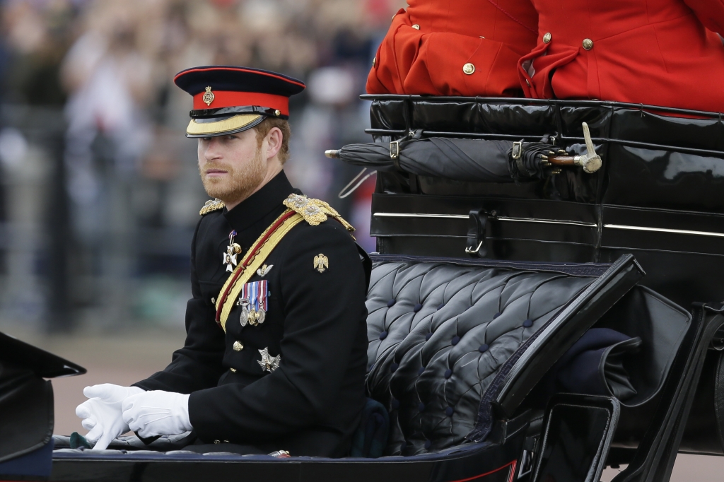 Britain's Britain's Prince Harry rides in a carriage during the Trooping The Colour parade at Buckingham Palace in London Saturday