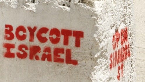 Pro-BDS graffiti sprayed on a roadblock in the West Bank city of Hebron reads'Boycott Israel