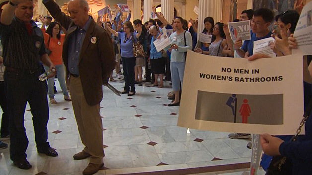 Protesters at the State House voice opposition to the transgender rights bill