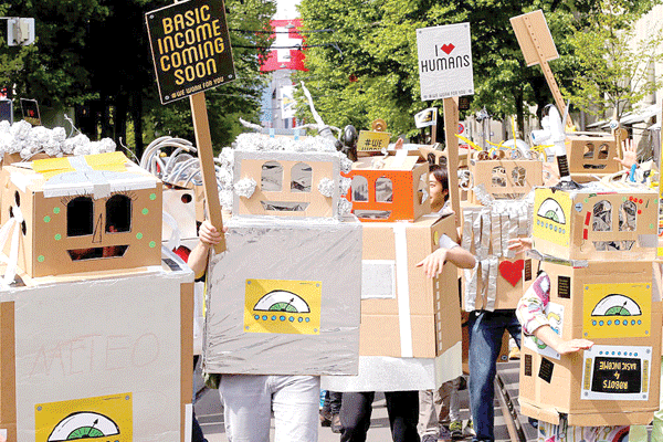 Protesters march in Zurich for a basic income for all Swiss citizens before the public vote