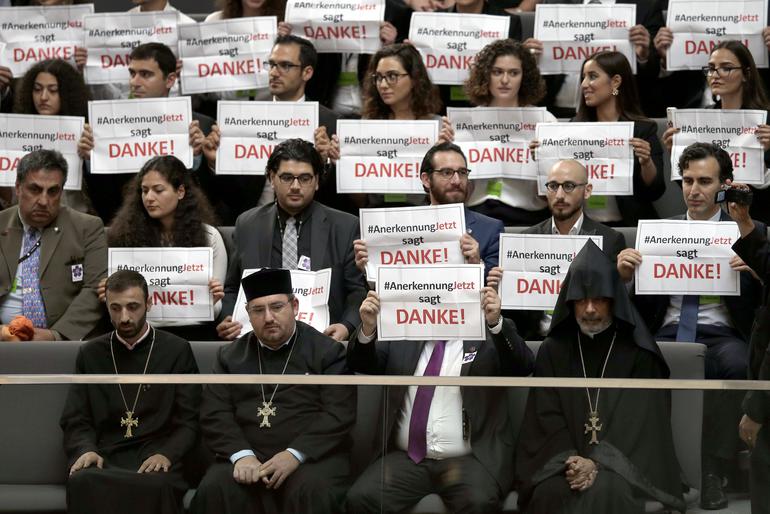 Protestors hold posters of the'recognition now organisation during meeting of the German Parliament