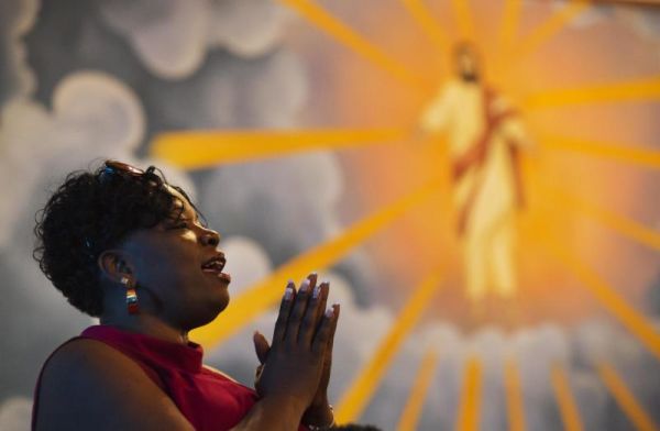 Parishioner Gail Smith prays against the backdrop