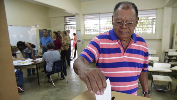 Puerto Rico resident Hector Alvarez casts his ballot during the US territory's Democratic primary election