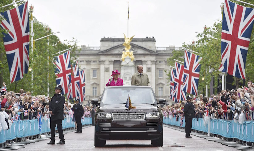 Queen Elizabeth II and the Duke of Edinburgh arrive at the Patron's Lunch in The Mall central London in honour of the her 90th birthday in an open topped Range Rover Sunday