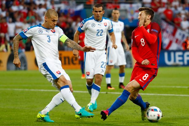 Martin Skrtel and Viktor Pecovsky in action with Adam Lallana