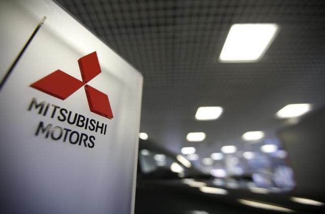 The logo of Mitsubishi Motors is seen on a board at a showroom in Moscow