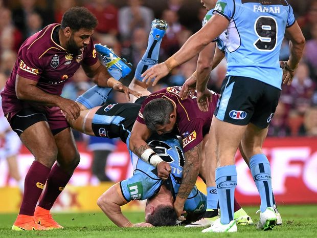 RUBBED OUT NSW’s Paul Gallen is tackled head-first into the turf by Queensland’s Sam Thaiday and Corey Parker during State of Origin II