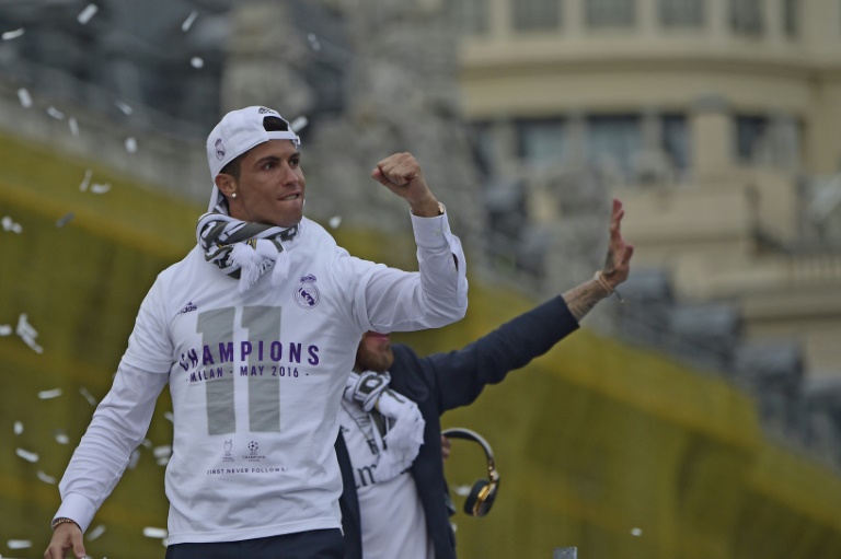 AFP  Javier Soriano Real Madrid's Cristiano Ronaldo celebrates with the team and thousands of delirious fans on the Plaza Cibeles in Madrid