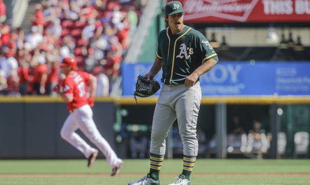 Oakland Athletics starting pitcher Daniel Mengden reacts after giving up a go-ahead two-run home run to Cincinnati Reds&#039 Jay Bruce left in the third inning of baseball game Saturday